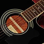 Black Acoustic Guitar on a Red Satin Background